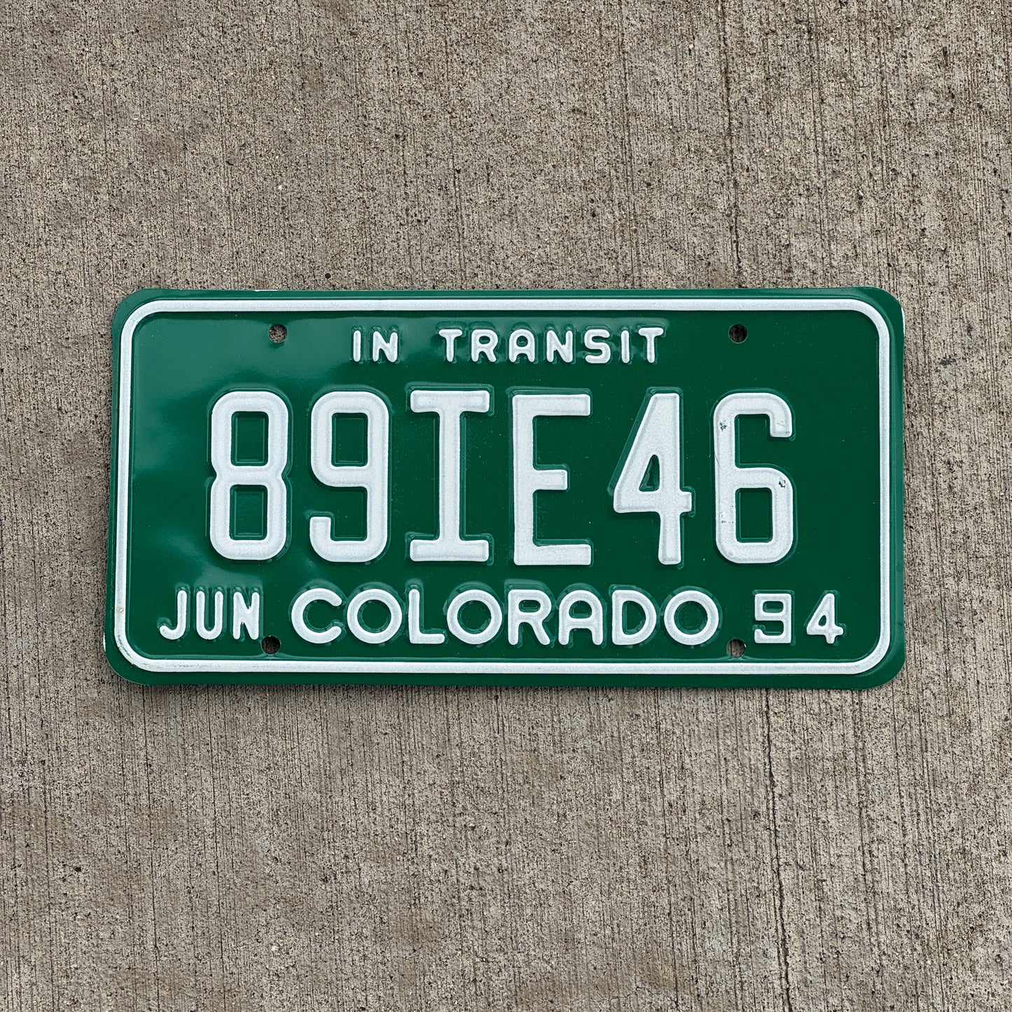 Photo of a 1994 Colorado In Transit Dealer License Plate Auto Tag Garage Decor Vintage 89 IE 46 with original patina