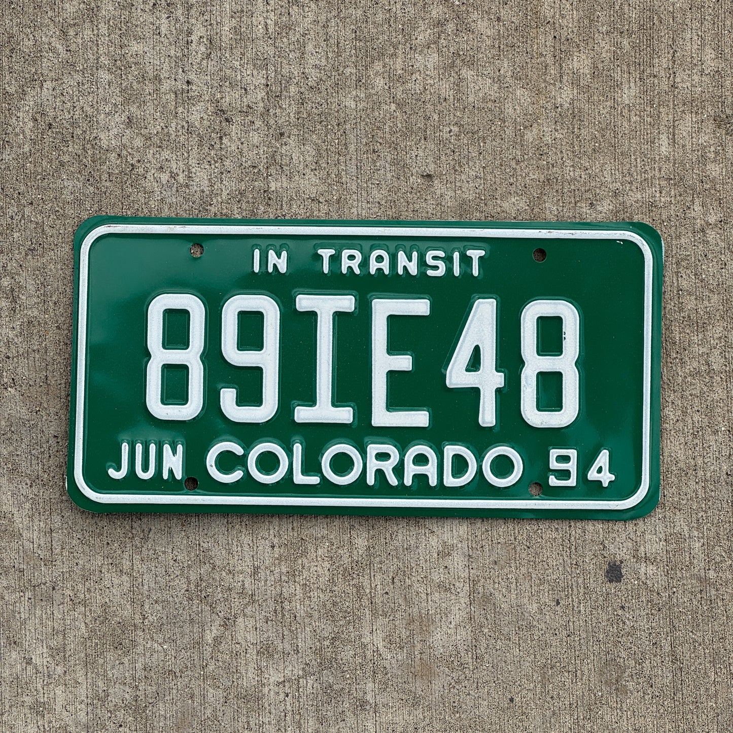 Photo of a 1994 Colorado In Transit Dealer License Plate Auto Tag Garage Decor Vintage 89 IE 48 with original patina