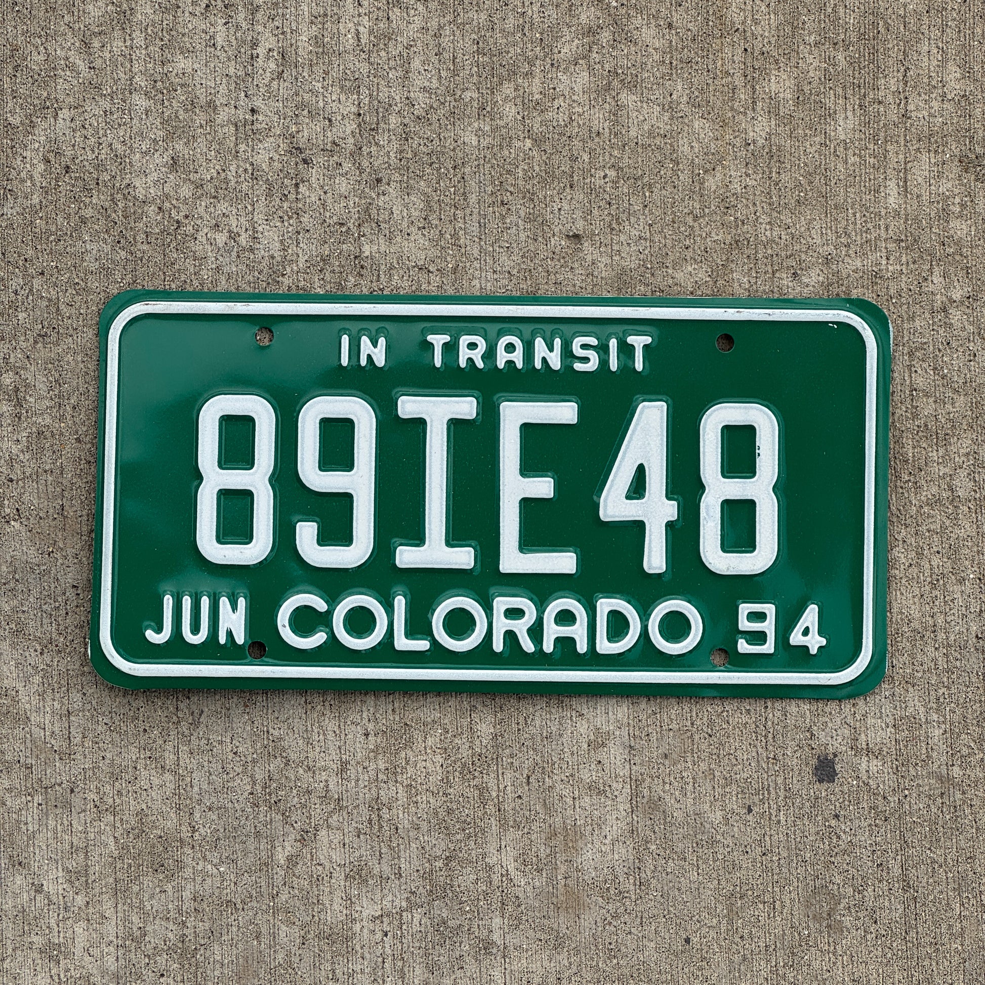 Photo of a 1994 Colorado In Transit Dealer License Plate Auto Tag Garage Decor Vintage 89 IE 48 with original patina