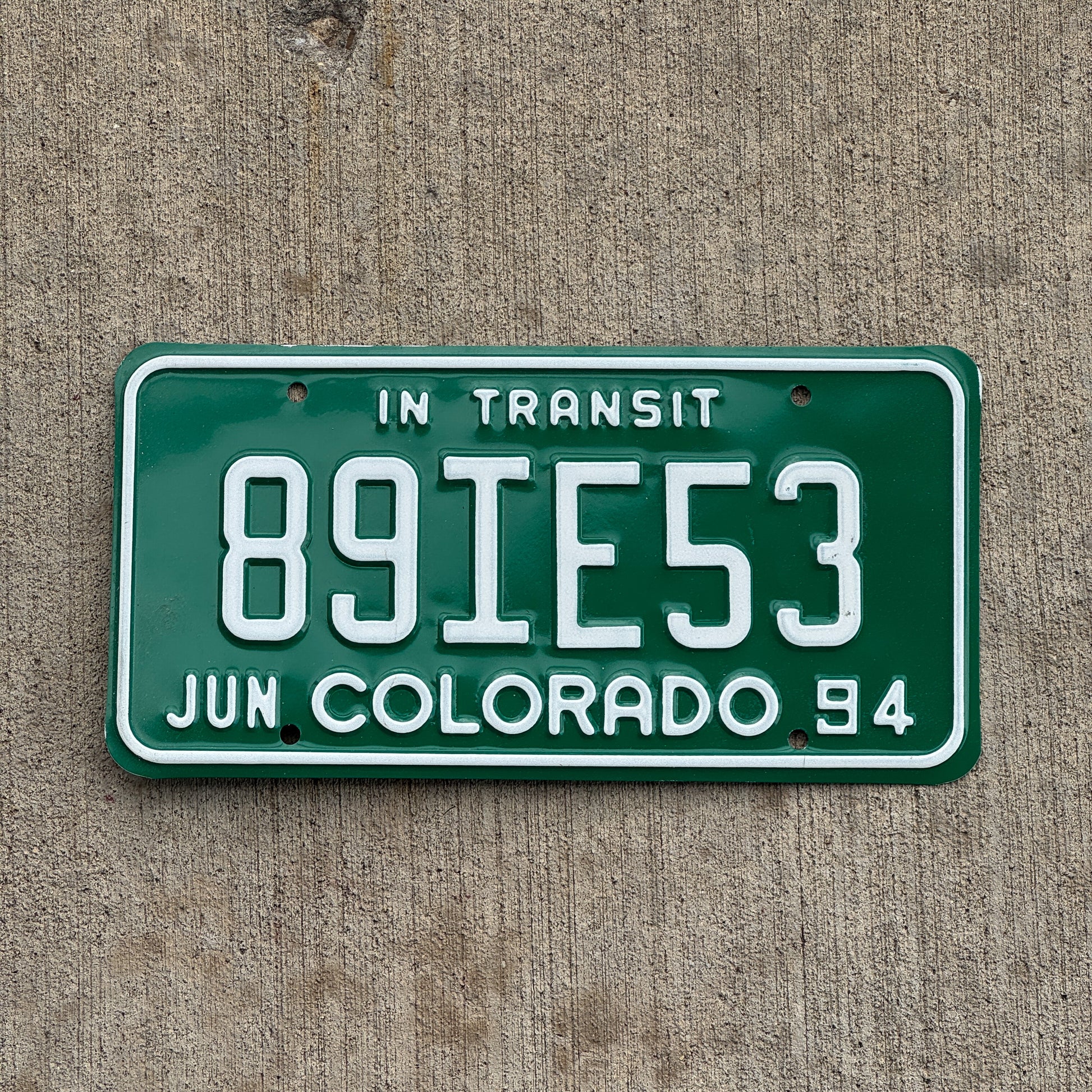 Photo of a 1994 Colorado In Transit Dealer License Plate Auto Tag Garage Decor Vintage 89 IE 53 with original patina