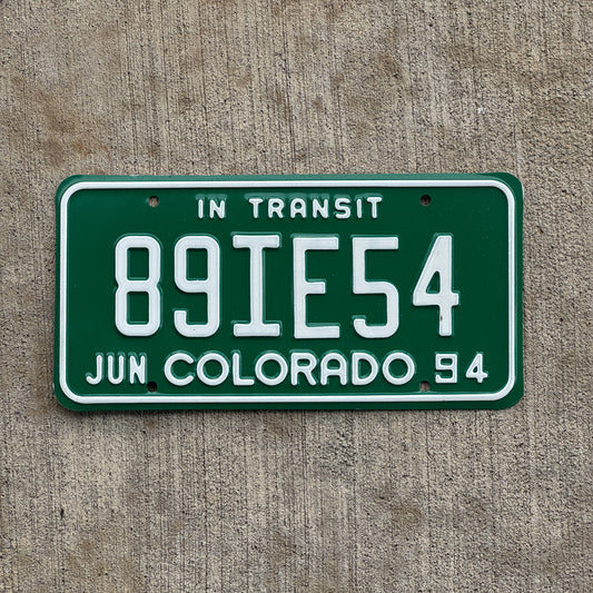 Photo of a 1994 Colorado In Transit Dealer License Plate Auto Tag Garage Decor Vintage 89 IE 54 with original patina