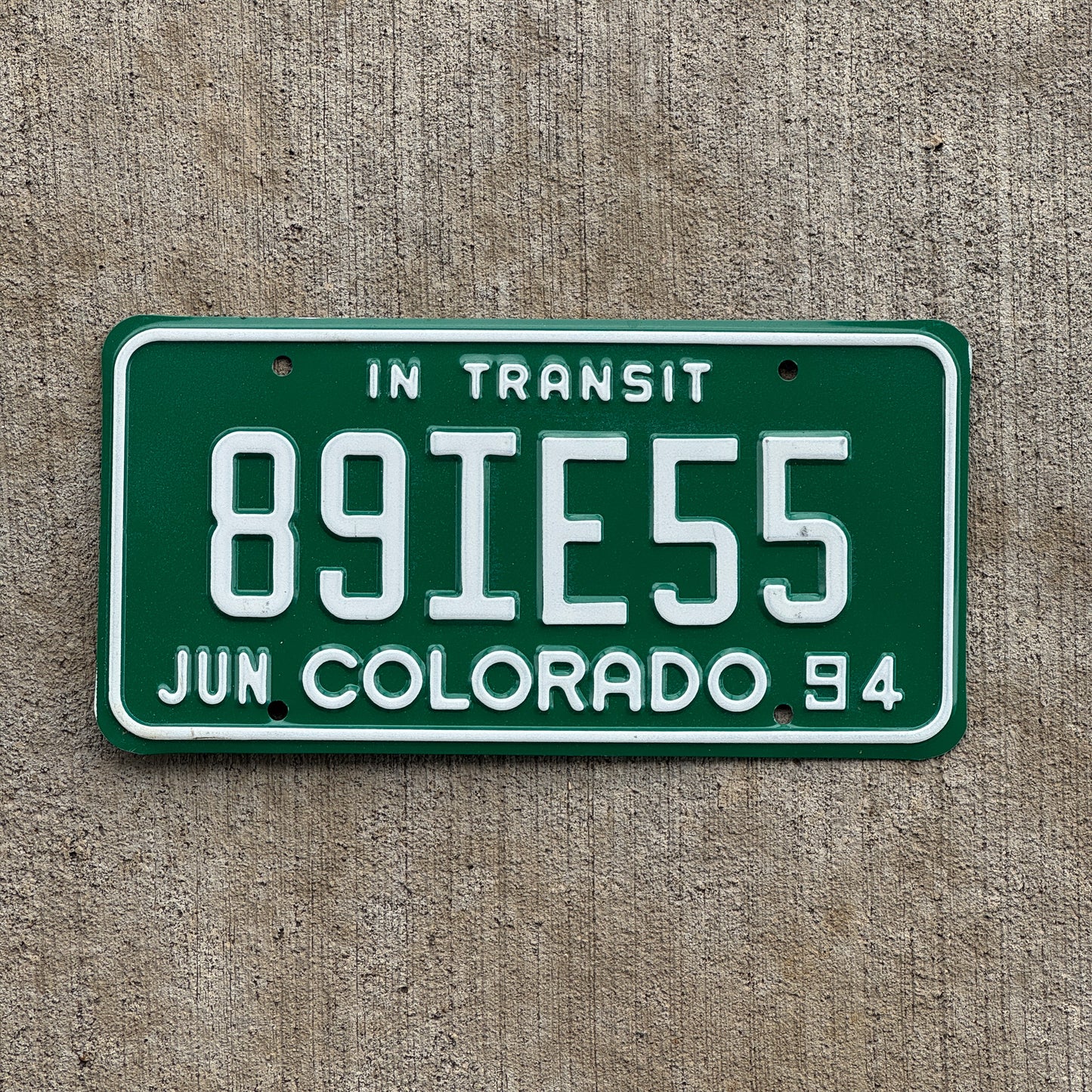 Photo of a 1994 Colorado In Transit Dealer License Plate Auto Tag Garage Decor Vintage 89 IE 55 with original patina