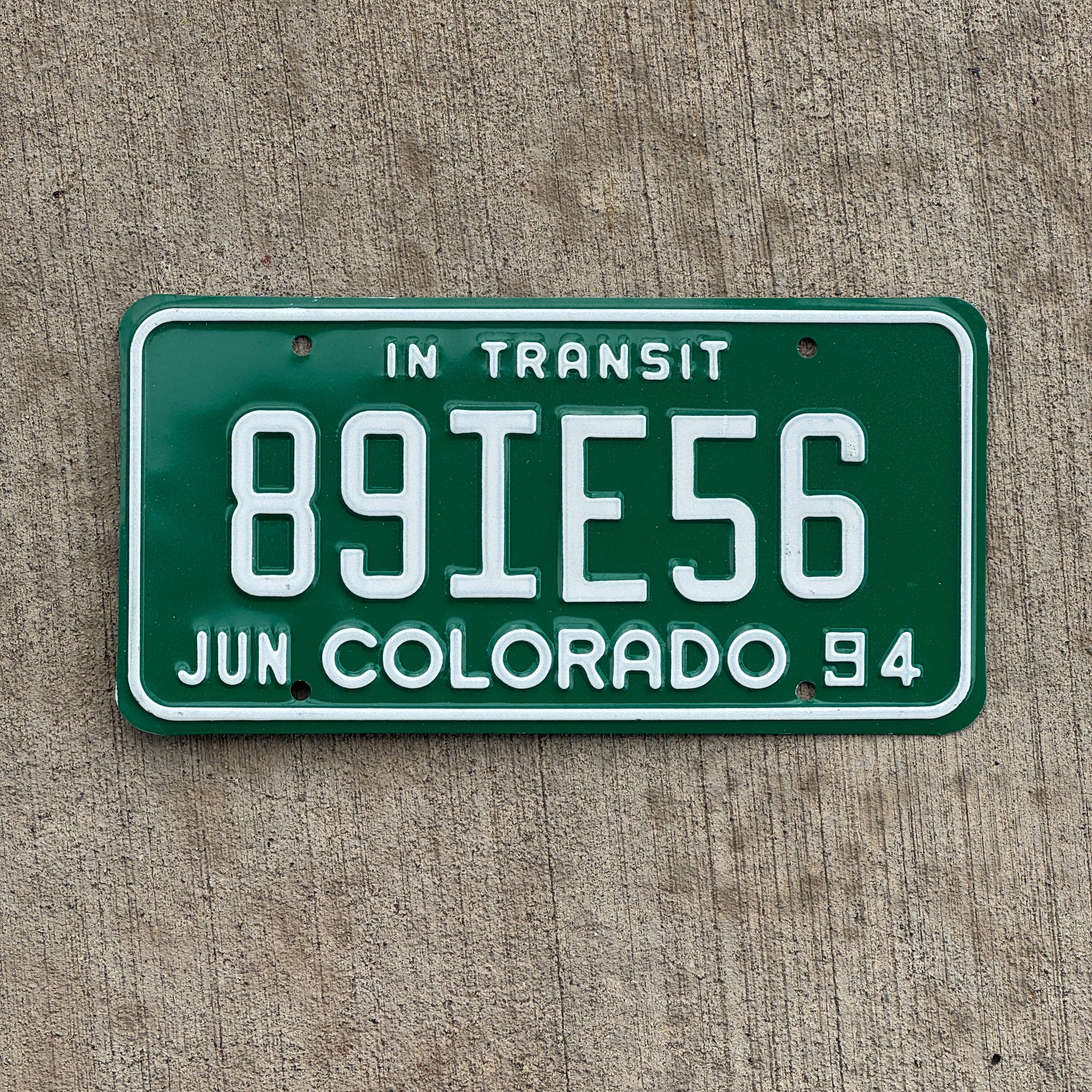 Photo of a 1994 Colorado In Transit Dealer License Plate Auto Tag Garage Decor Vintage 89 IE 56 with original patina