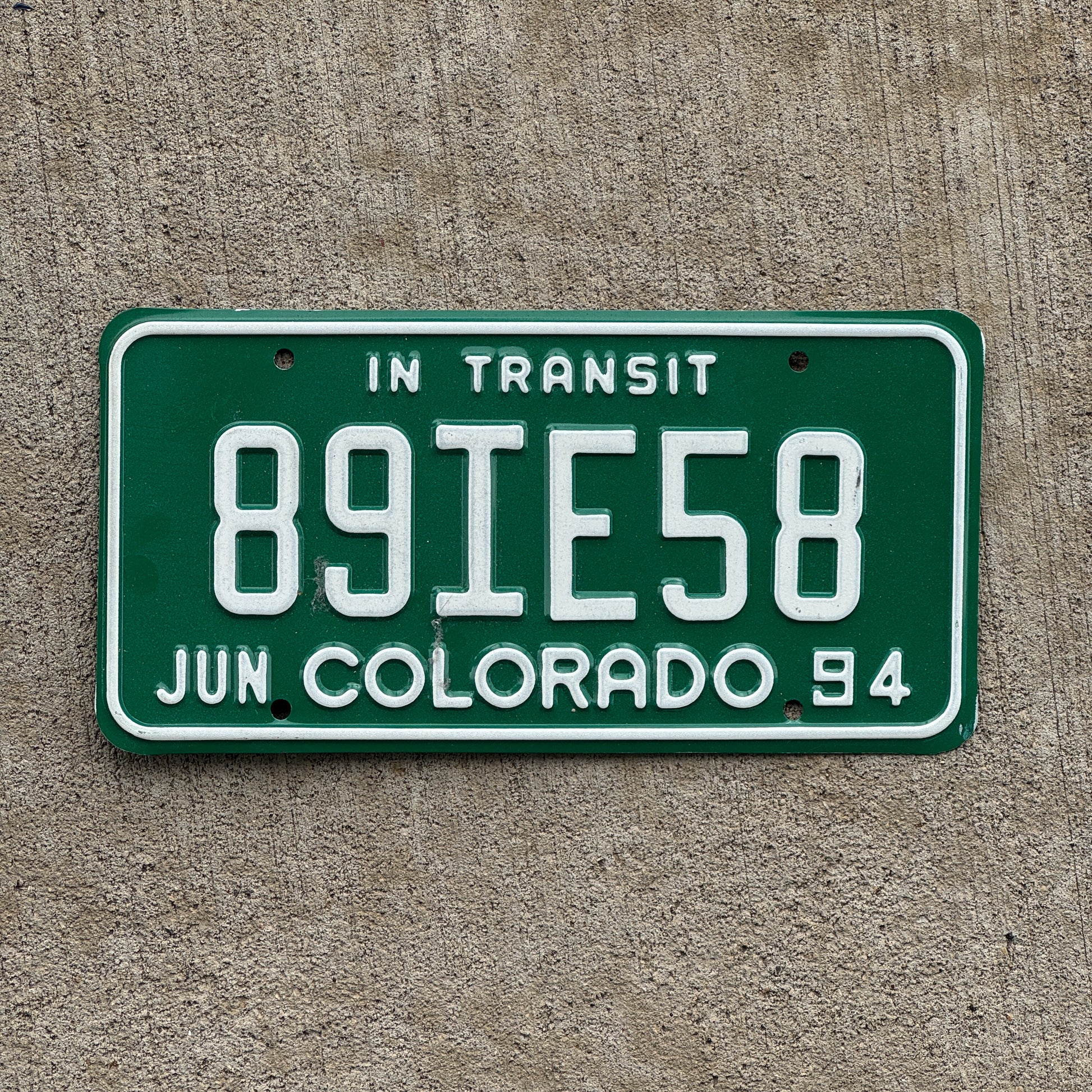 Photo of a 1994 Colorado In Transit Dealer License Plate Auto Tag Garage Decor Vintage 89 IE 58 with original patina