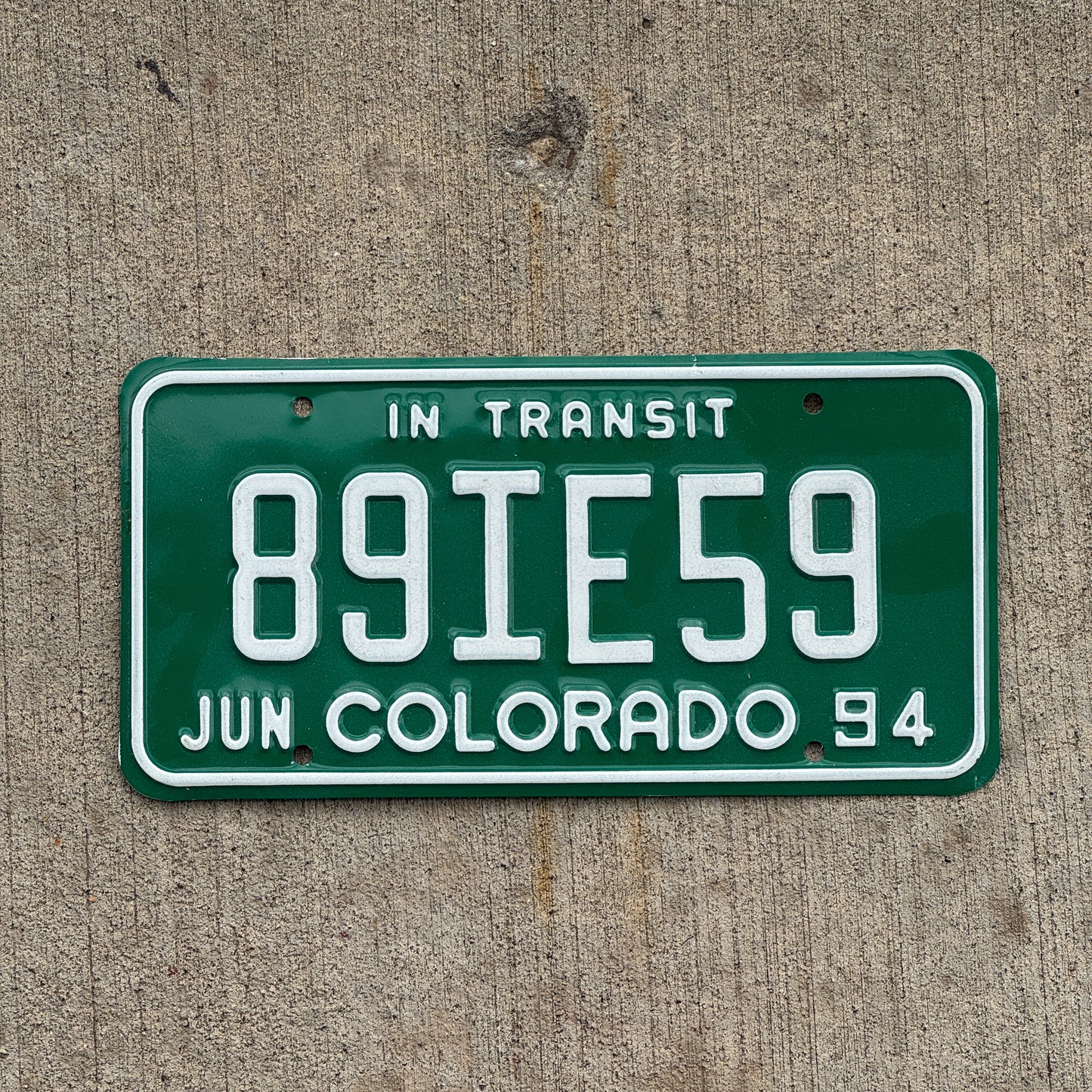 Photo of a 1994 Colorado In Transit Dealer License Plate Auto Tag Garage Decor Vintage 89 IE 59 with original patina