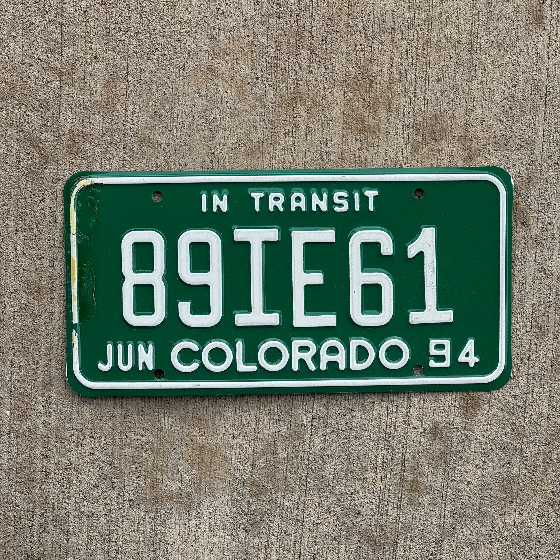 Photo of a 1994 Colorado In Transit Dealer License Plate Auto Tag Garage Decor Vintage 89 IE 61 with original patina