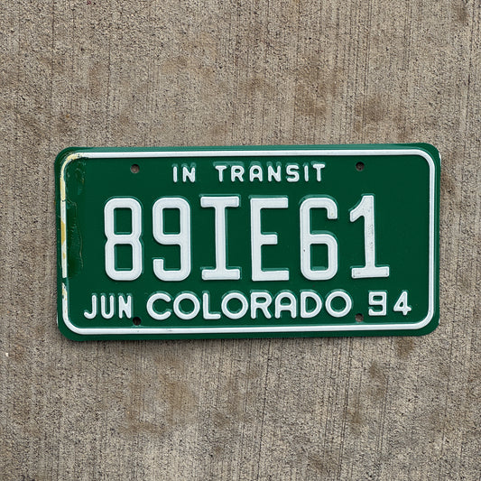 Photo of a 1994 Colorado In Transit Dealer License Plate Auto Tag Garage Decor Vintage 89 IE 61 with original patina