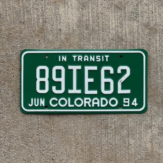 Photo of a 1994 Colorado In Transit Dealer License Plate Auto Tag Garage Decor Vintage 89 IE 62 with original patina