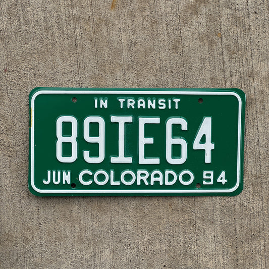 Photo of a 1994 Colorado In Transit Dealer License Plate Auto Tag Garage Decor Vintage 89 IE 64 with original patina
