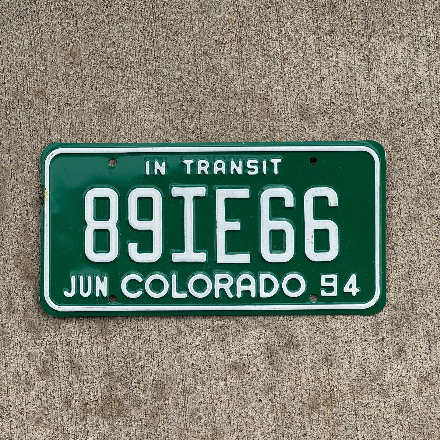 Photo of a 1994 Colorado In Transit Dealer License Plate Auto Tag Garage Decor Vintage 89 IE 66 with original patina