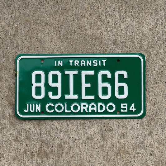 Photo of a 1994 Colorado In Transit Dealer License Plate Auto Tag Garage Decor Vintage 89 IE 66 with original patina