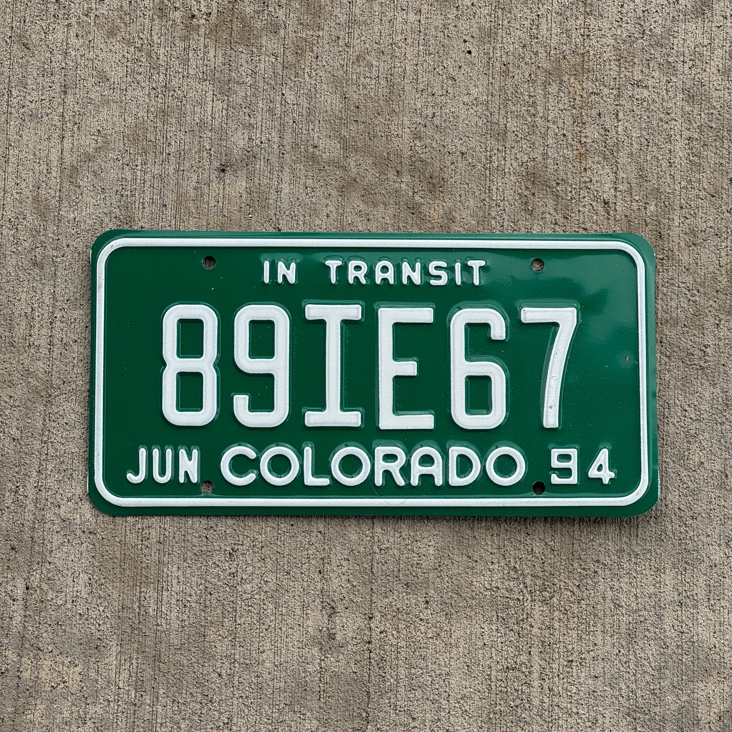 Photo of a 1994 Colorado In Transit Dealer License Plate Auto Tag Garage Decor Vintage 89 IE 67 with original patina