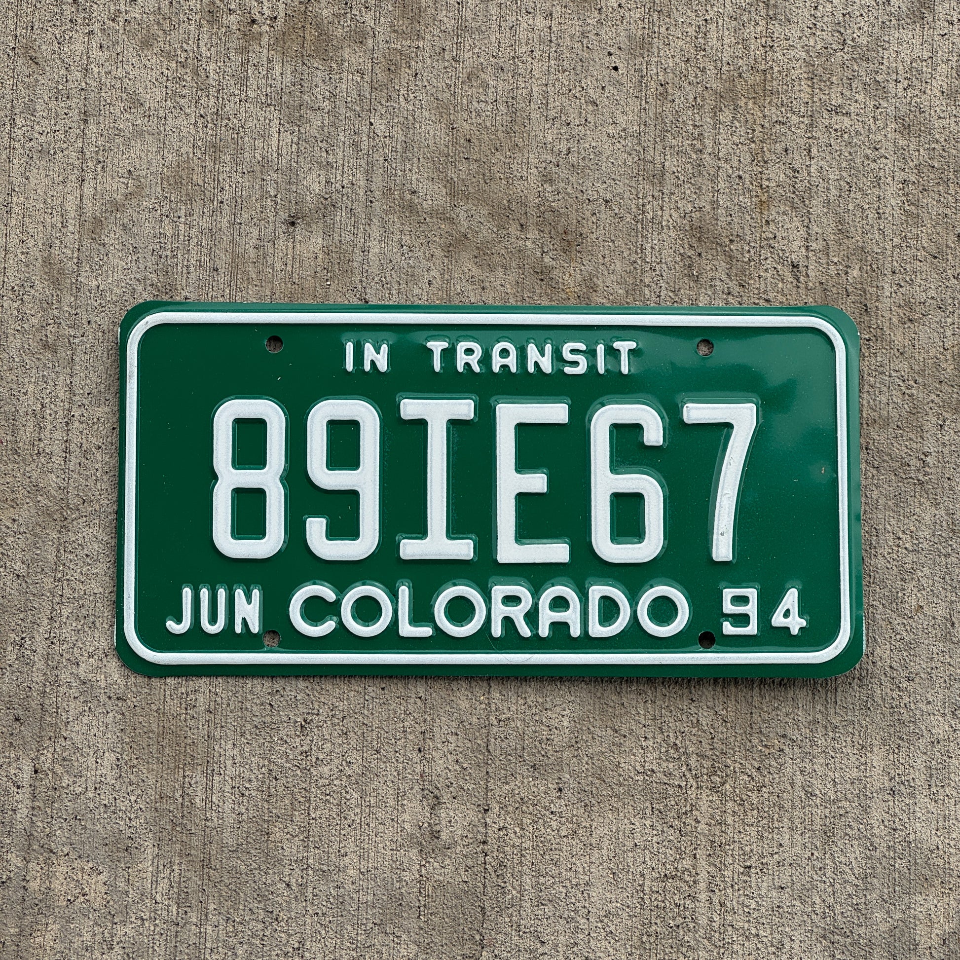 Photo of a 1994 Colorado In Transit Dealer License Plate Auto Tag Garage Decor Vintage 89 IE 67 with original patina