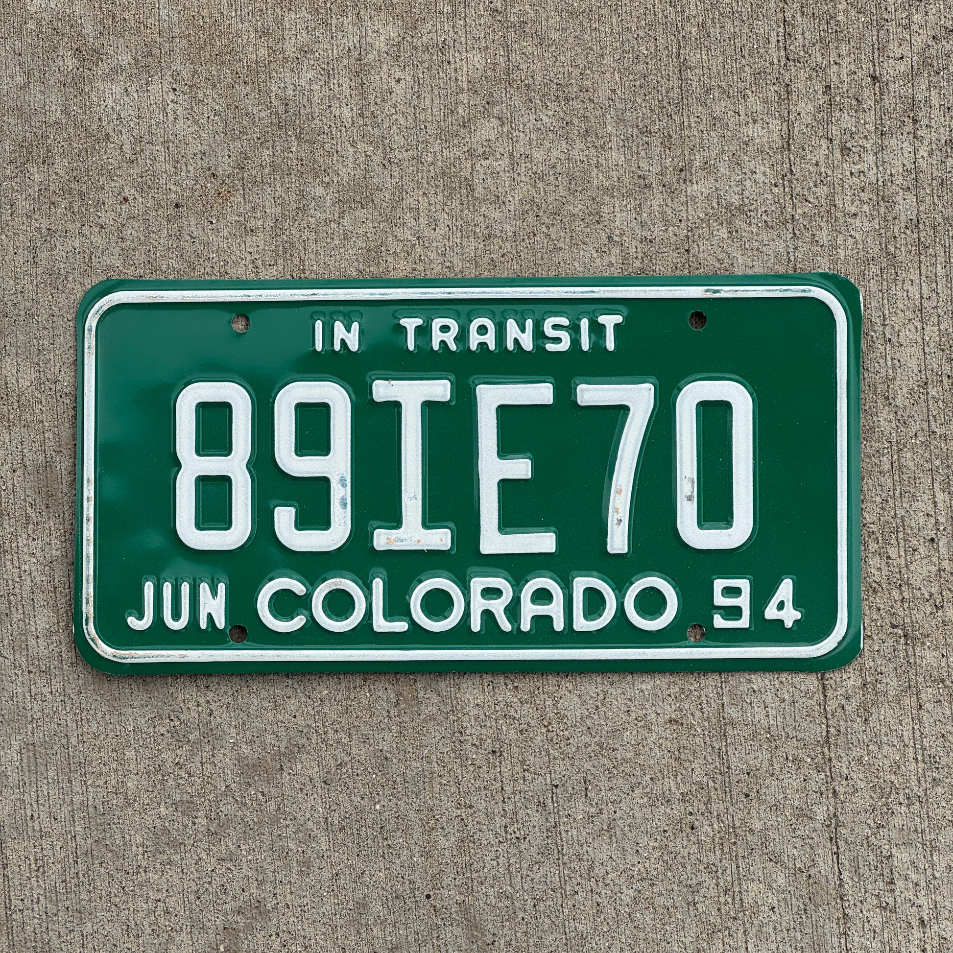 Photo of a 1994 Colorado In Transit Dealer License Plate Auto Tag Garage Decor Vintage 89 IE 70 with original patina