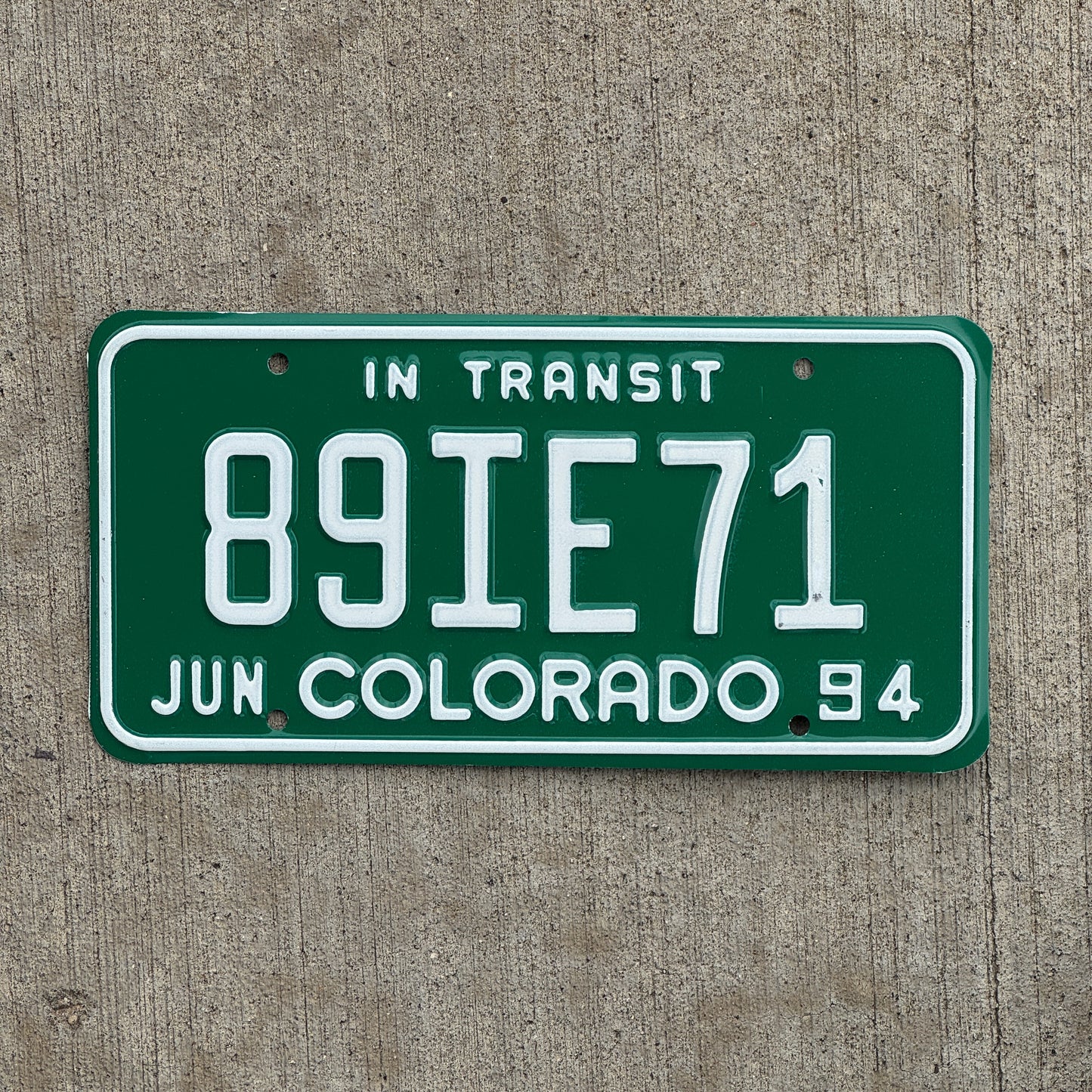 Photo of a 1994 Colorado In Transit Dealer License Plate Auto Tag Garage Decor Vintage 89 IE 71 with original patina