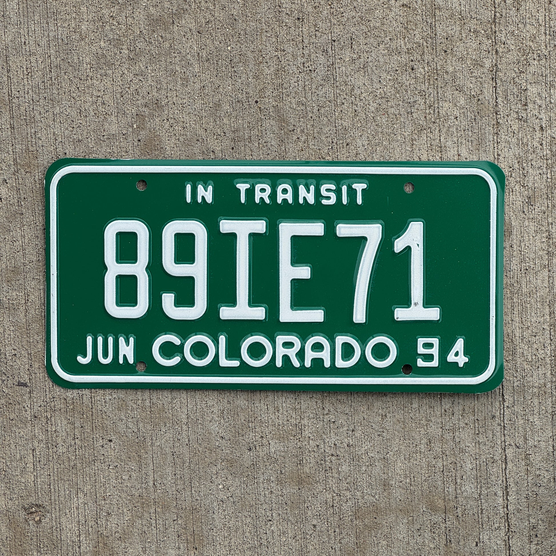 Photo of a 1994 Colorado In Transit Dealer License Plate Auto Tag Garage Decor Vintage 89 IE 71 with original patina