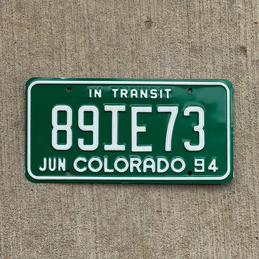 Photo of a 1994 Colorado In Transit Dealer License Plate Auto Tag Garage Decor Vintage 89 IE 73 with original patina