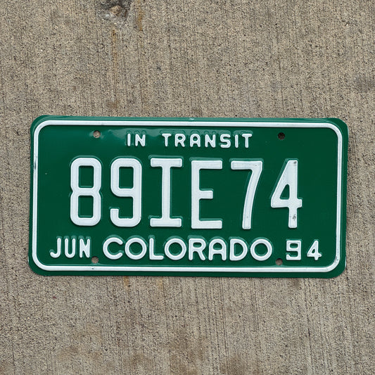 Photo of a 1994 Colorado In Transit Dealer License Plate Auto Tag Garage Decor Vintage 89 IE 74 with original patina