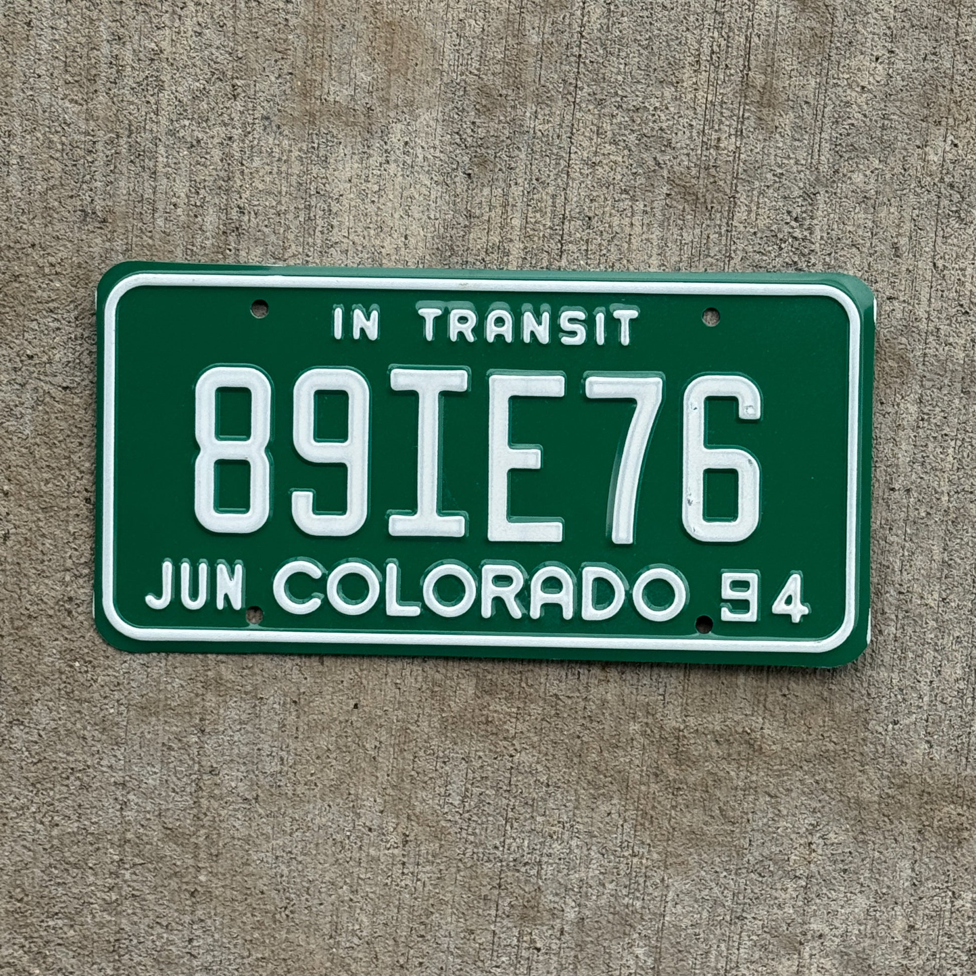 Photo of a 1994 Colorado In Transit Dealer License Plate Auto Tag Garage Decor Vintage 89 IE 76 with original patina
