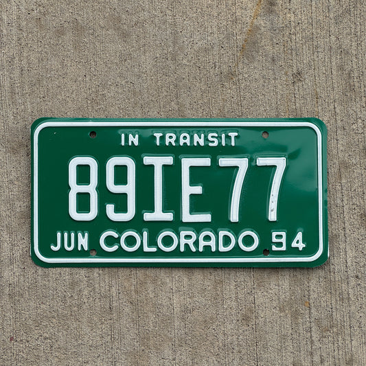 Photo of a 1994 Colorado In Transit Dealer License Plate Auto Tag Garage Decor Vintage 89 IE 77 with original patina