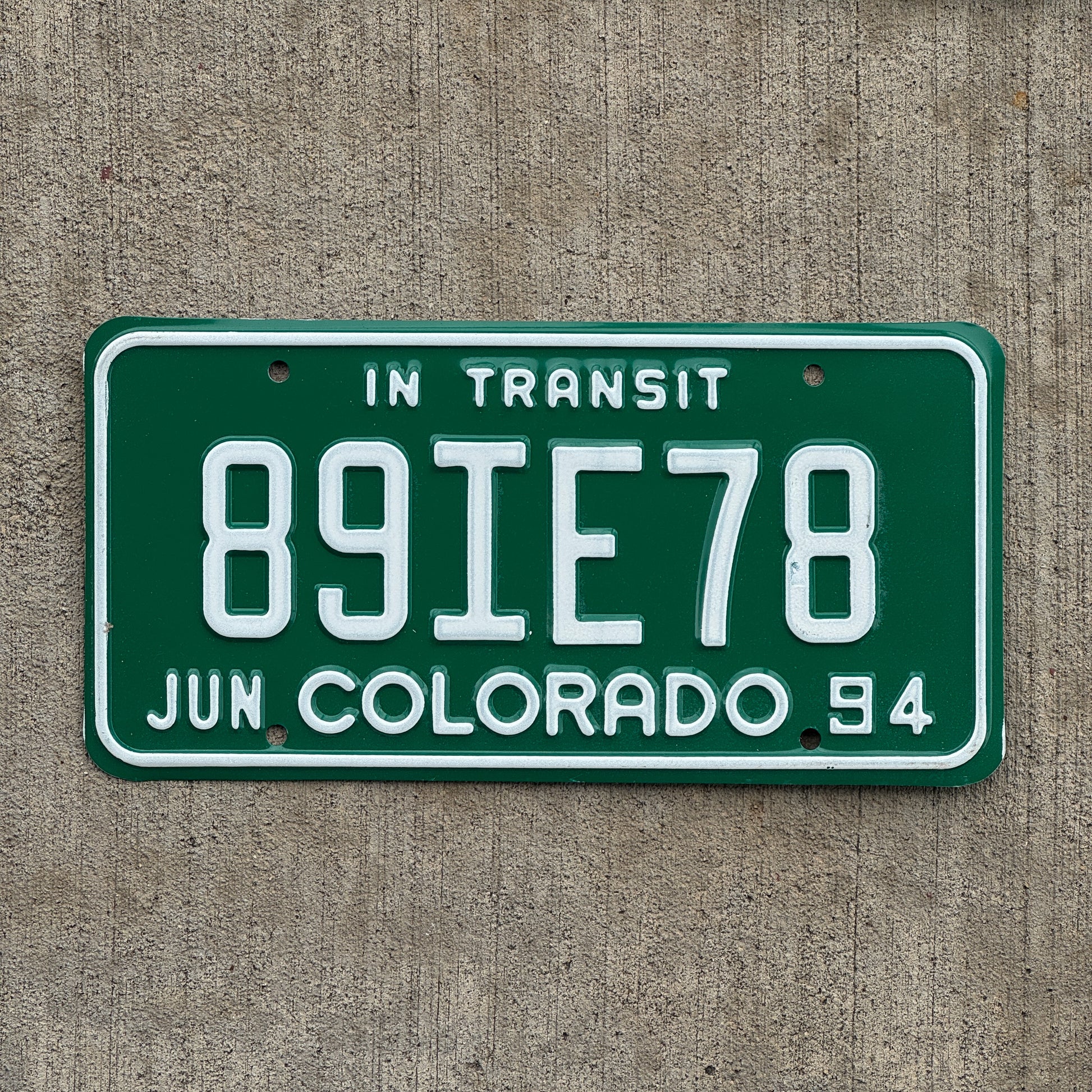 Photo of a 1994 Colorado In Transit Dealer License Plate Auto Tag Garage Decor Vintage 89 IE 78 with original patina