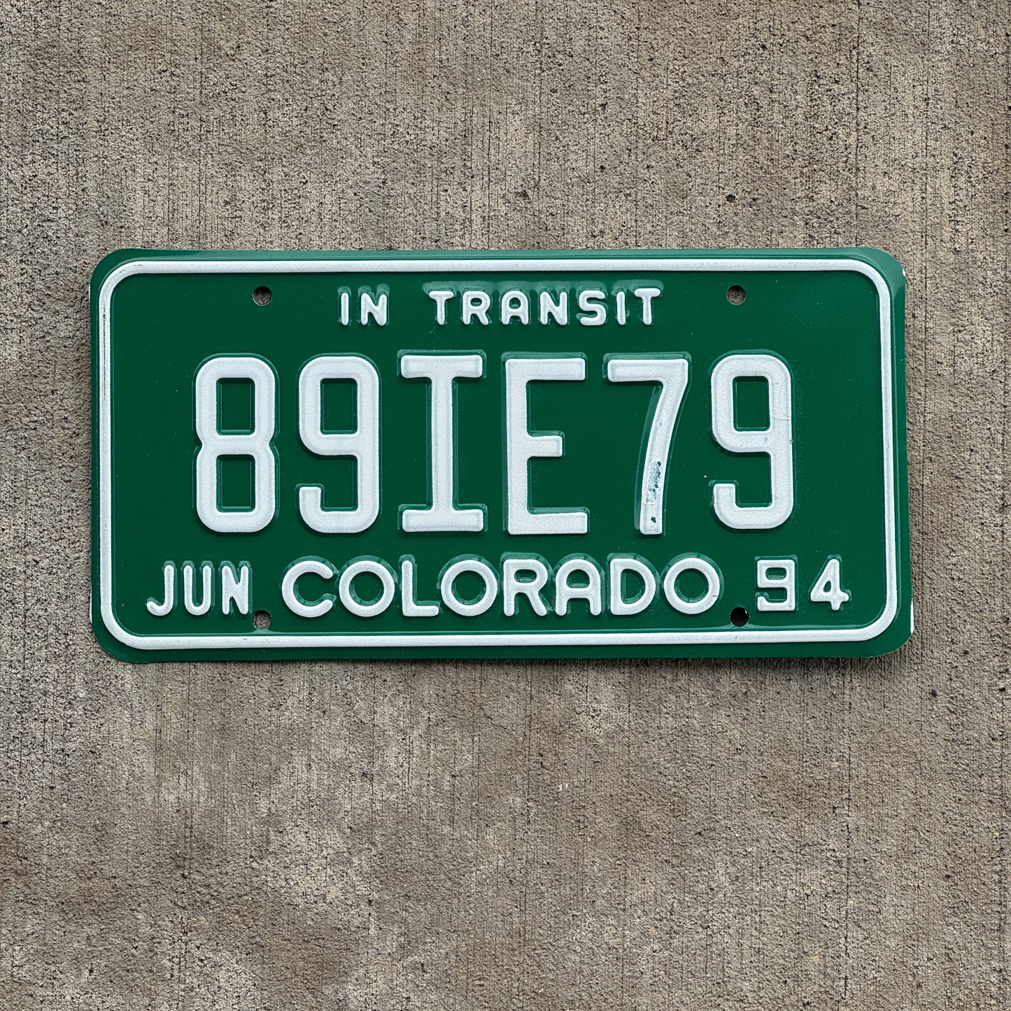 Photo of a 1994 Colorado In Transit Dealer License Plate Auto Tag Garage Decor Vintage 89 IE 79 with original patina