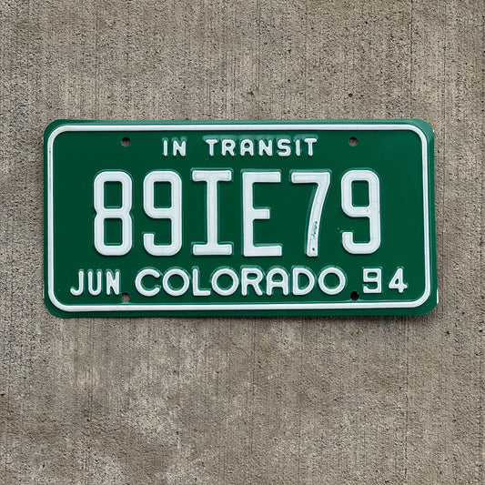 Photo of a 1994 Colorado In Transit Dealer License Plate Auto Tag Garage Decor Vintage 89 IE 79 with original patina