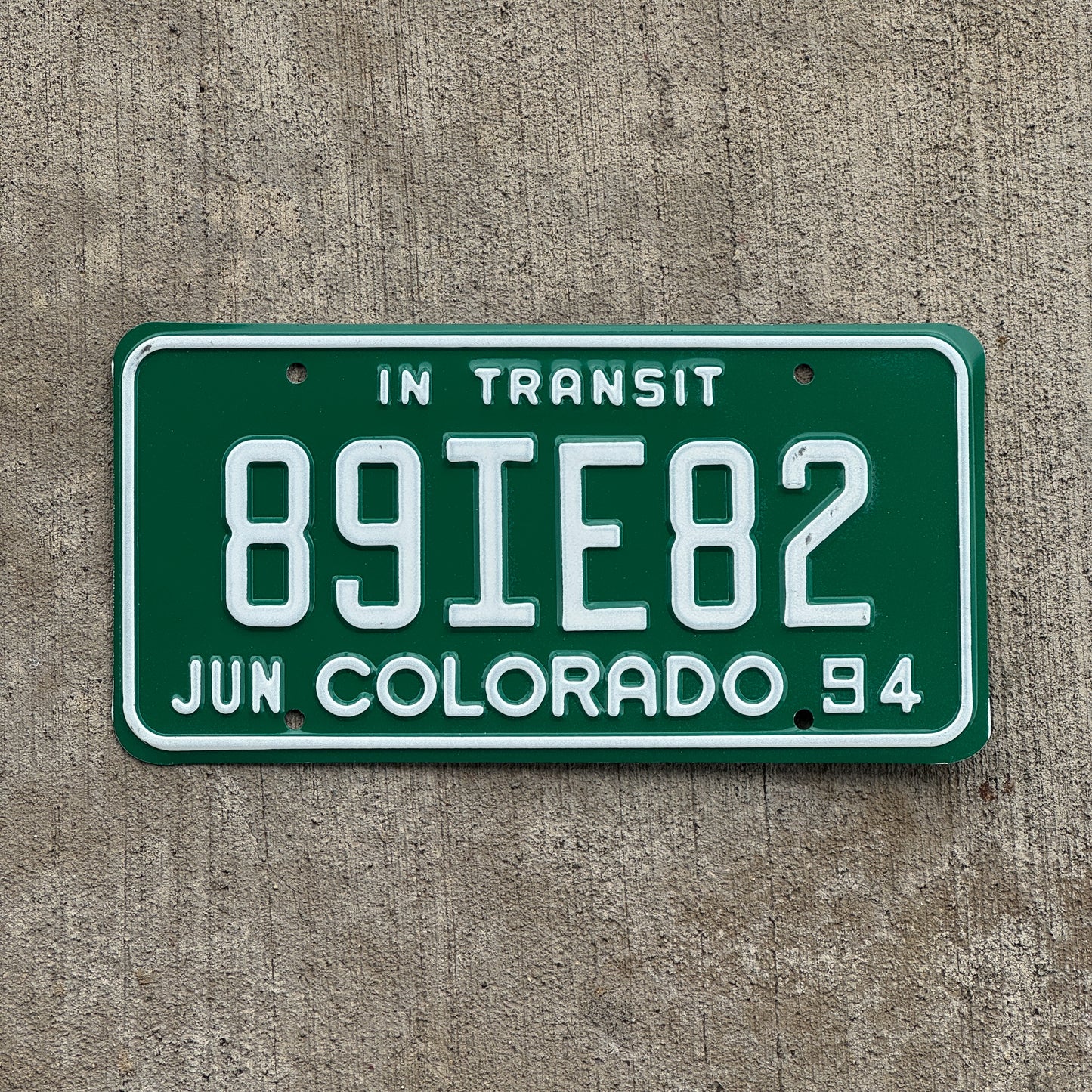Photo of a 1994 Colorado In Transit Dealer License Plate Auto Tag Garage Decor Vintage 89 IE 82 with original patina