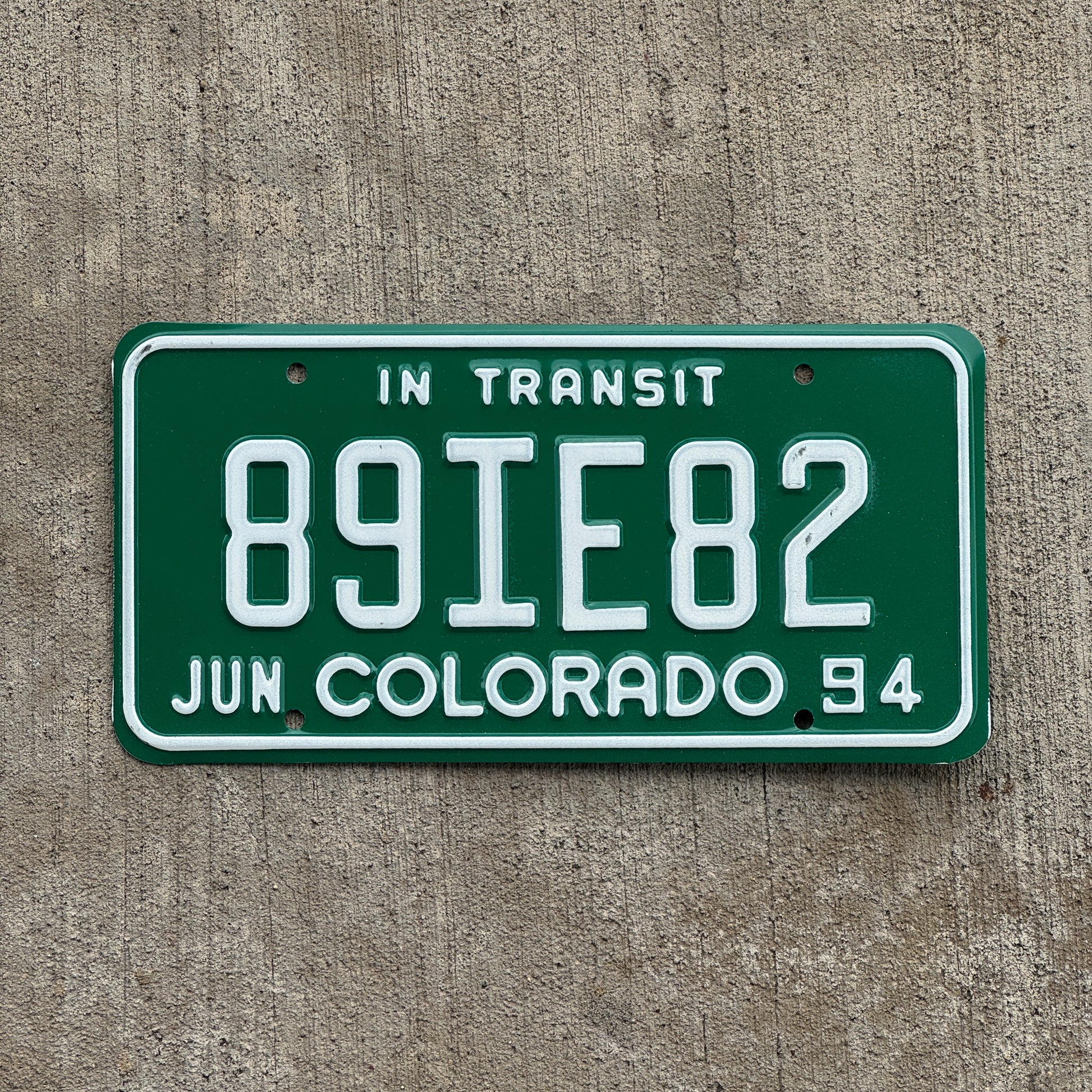 Photo of a 1994 Colorado In Transit Dealer License Plate Auto Tag Garage Decor Vintage 89 IE 82 with original patina