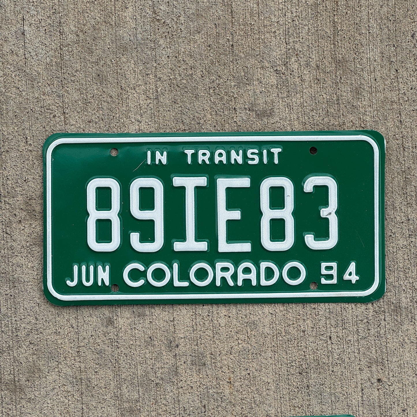 Photo of a 1994 Colorado In Transit Dealer License Plate Auto Tag Garage Decor Vintage 89 IE 83 with original patina