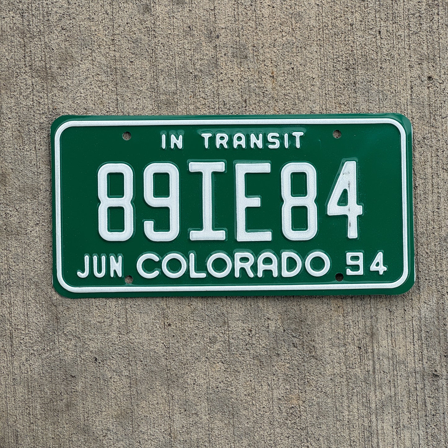Photo of a 1994 Colorado In Transit Dealer License Plate Auto Tag Garage Decor Vintage 89 IE 84 with original patina