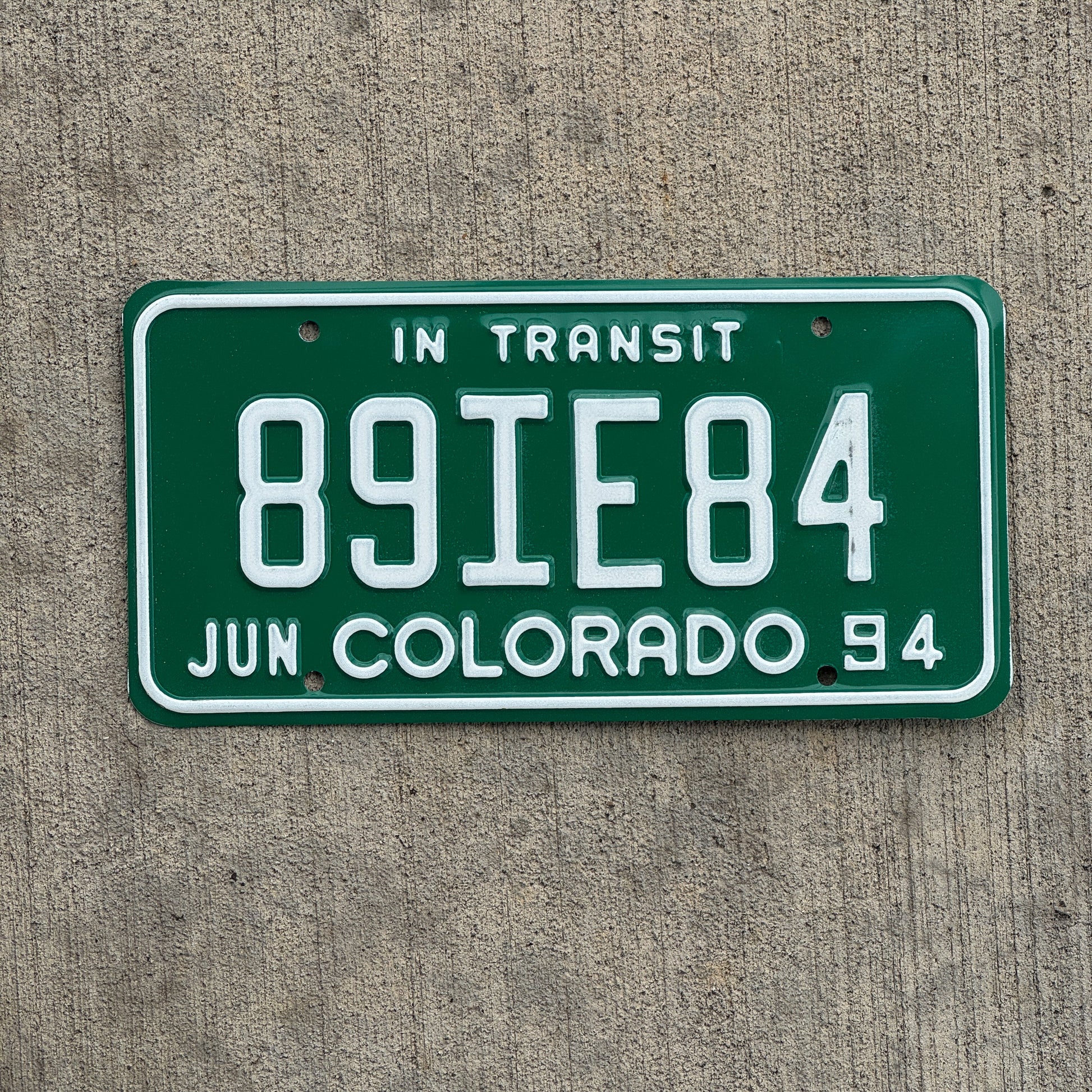 Photo of a 1994 Colorado In Transit Dealer License Plate Auto Tag Garage Decor Vintage 89 IE 84 with original patina