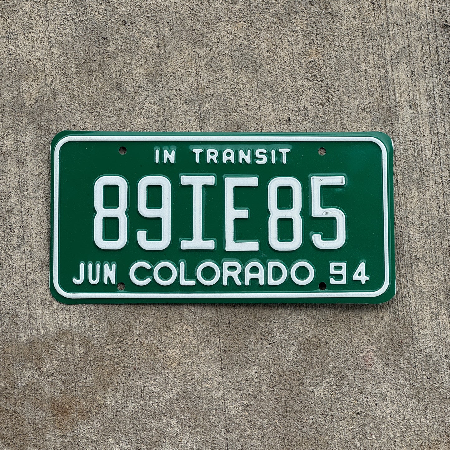 Photo of a 1994 Colorado In Transit Dealer License Plate Auto Tag Garage Decor Vintage 89 IE 85 with original patina