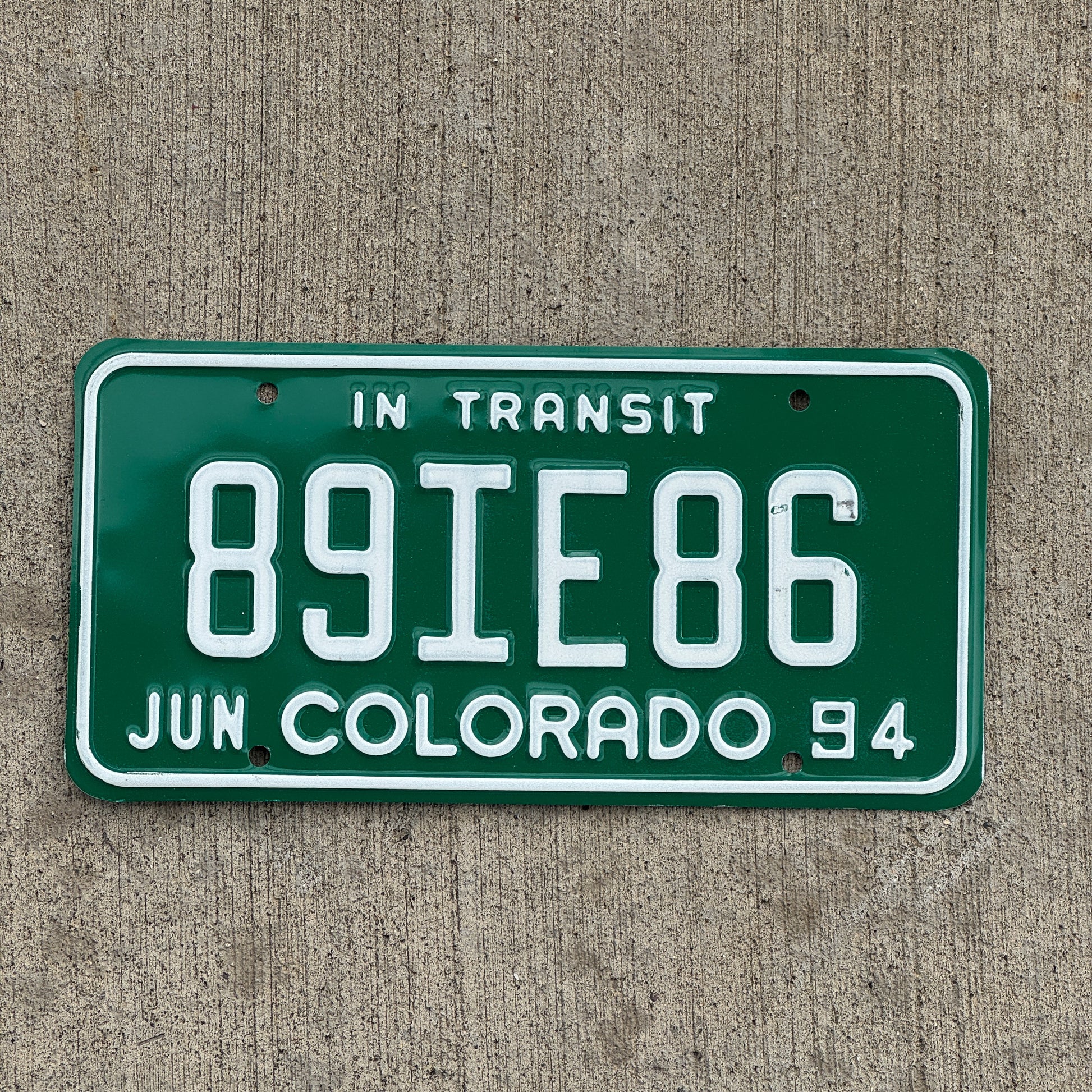 Photo of a 1994 Colorado In Transit Dealer License Plate Auto Tag Garage Decor Vintage 89 IE 86 with original patina