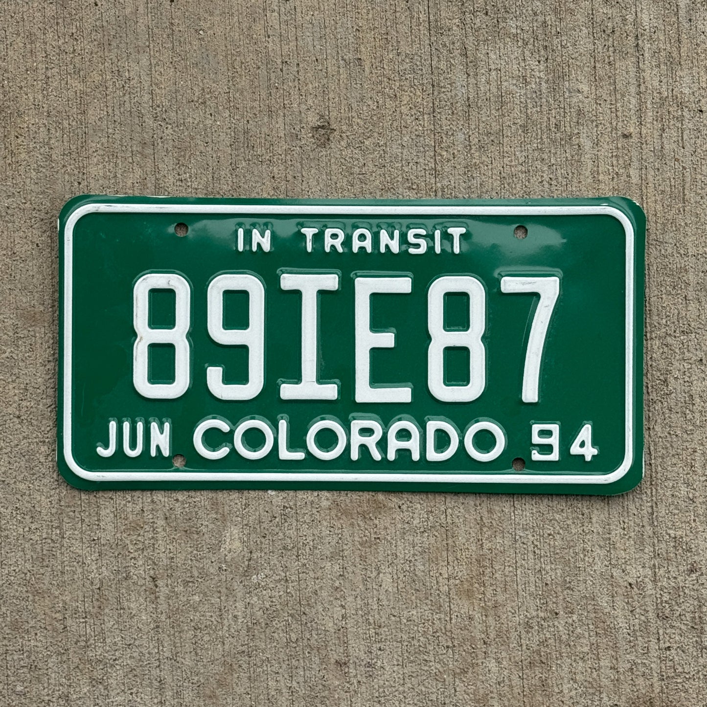 Photo of a 1994 Colorado In Transit Dealer License Plate Auto Tag Garage Decor Vintage 89 IE 87 with original patina