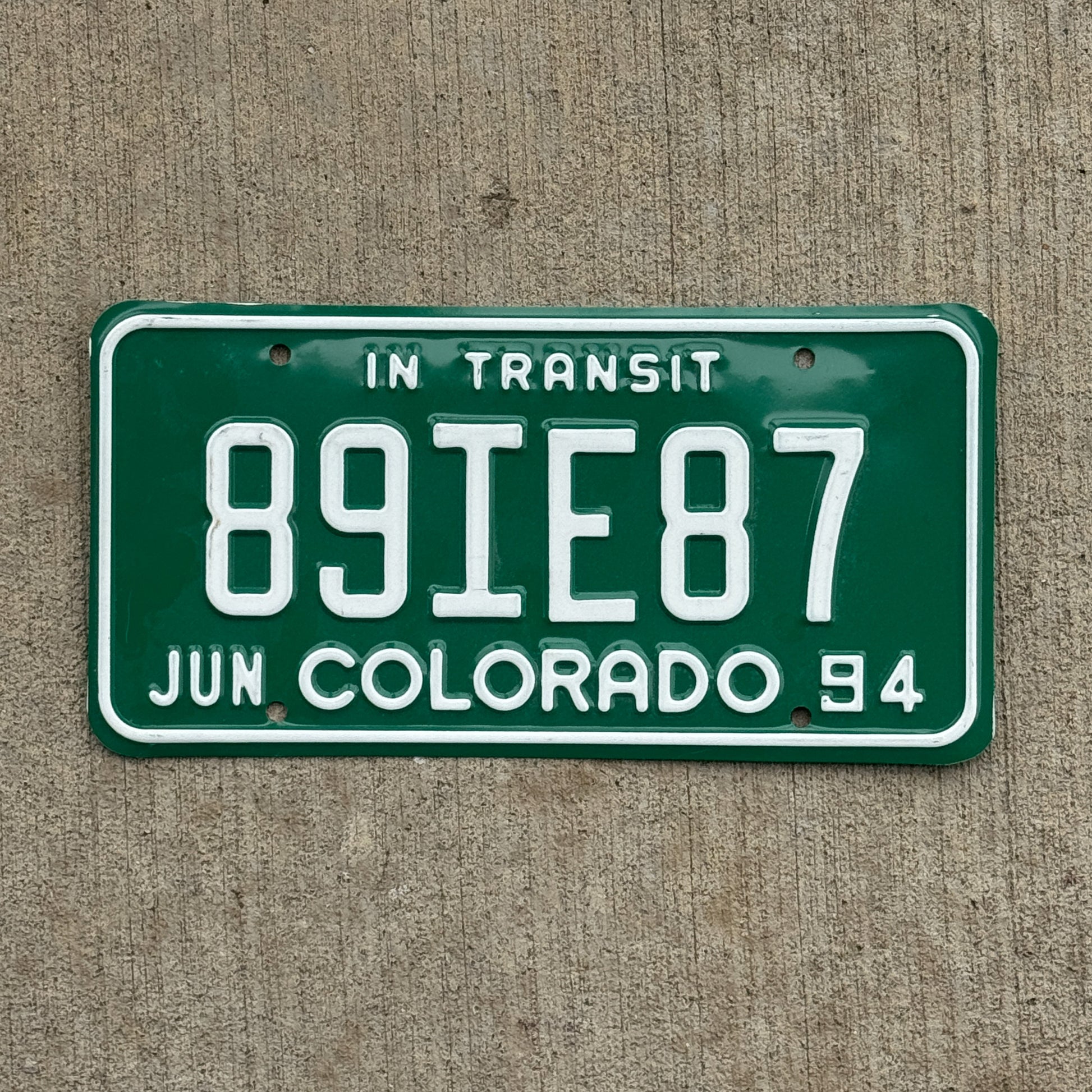 Photo of a 1994 Colorado In Transit Dealer License Plate Auto Tag Garage Decor Vintage 89 IE 87 with original patina