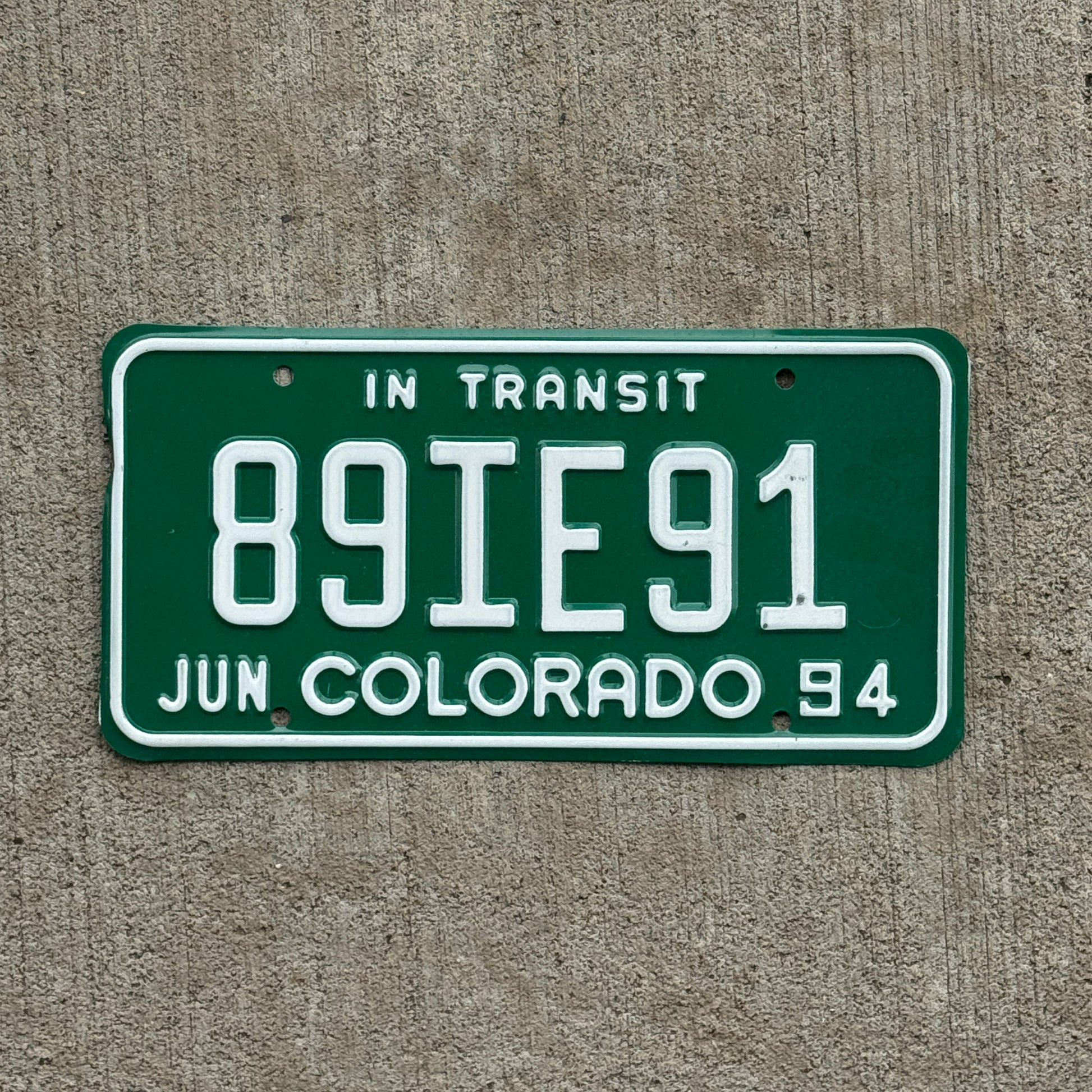 Photo of a 1994 Colorado In Transit Dealer License Plate Auto Tag Garage Decor Vintage 89 IE 91 with original patina