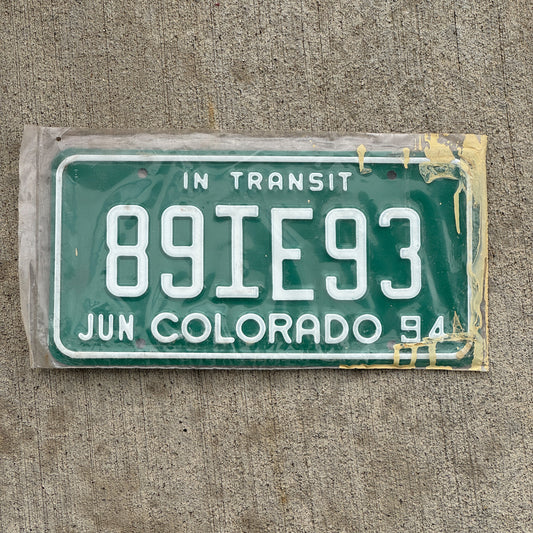 Photo of a 1994 Colorado In Transit Dealer License Plate Auto Tag Garage Decor Vintage New Old Stock NOS 89 IE 93 with original patina