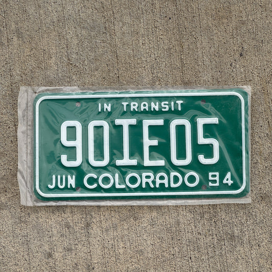 Photo of a 1994 Colorado In Transit Dealer License Plate Auto Tag Garage Decor Vintage New Old Stock NOS 90 IE 05 with original patina