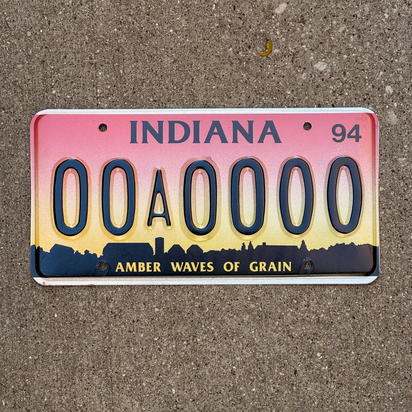 Photo of a 1994 Indiana Sample License Plate Auto Tag 3 Vintage 00A0000 with original patina