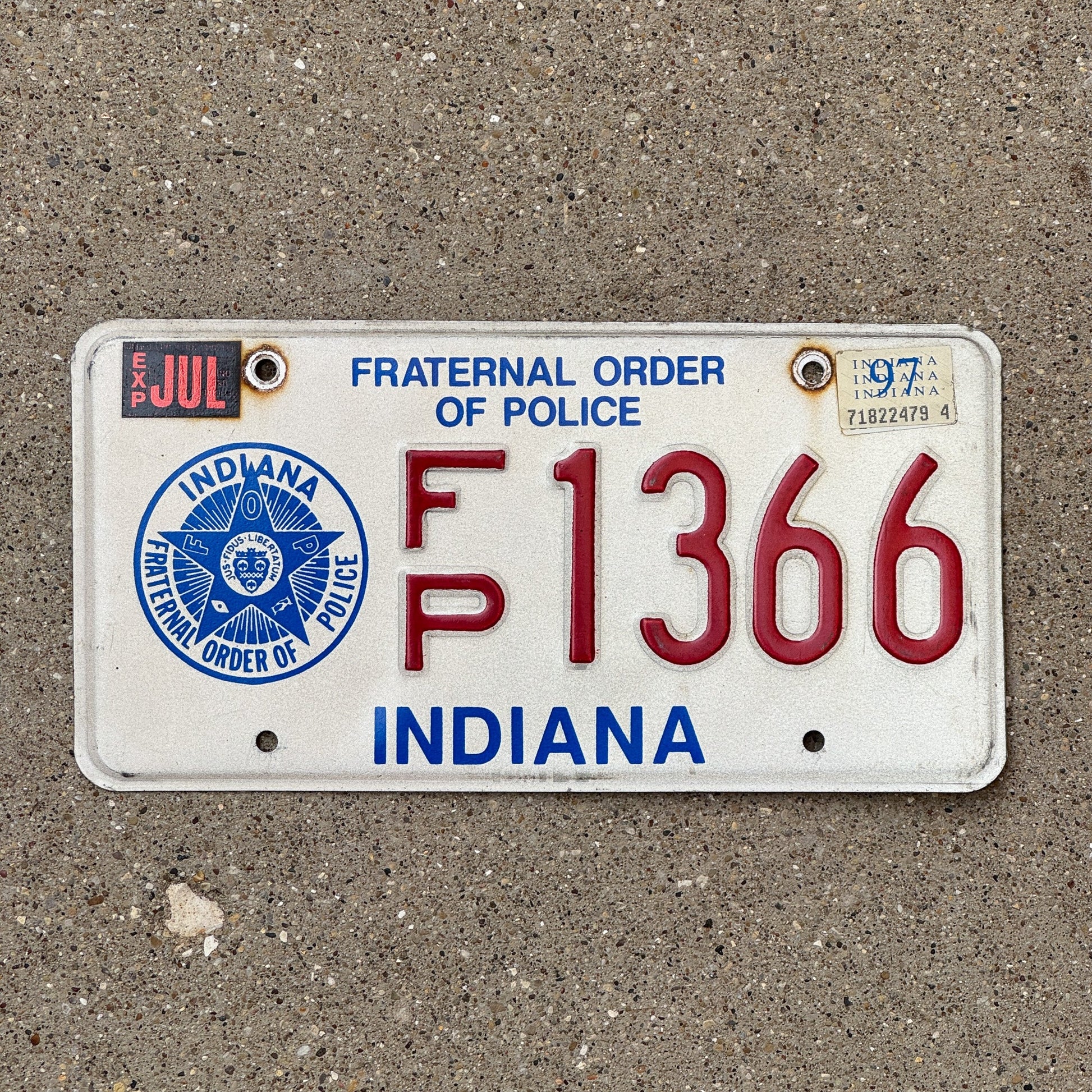 Photo of a 1995 1997 Indiana Fraternal Order of Police License Plate Auto Tag Garage Decor Vintage Law Enforcement FP 1366 with original patina