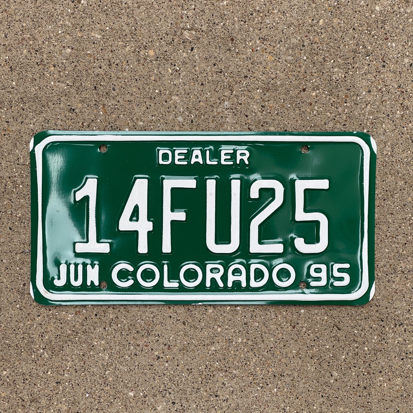 Photo of a 1995 Colorado Dealer License Plate Auto Tag Garage Decor Vintage Swear 14 FU 25