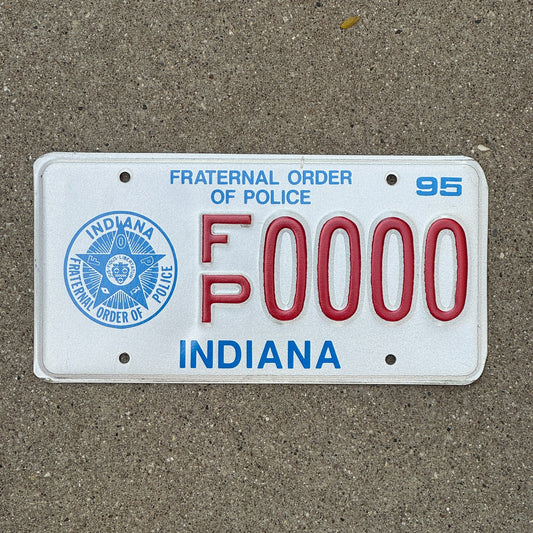 Photo of a 1995 Indiana Graphic Sample License Plate Auto Tag Garage Decor Vintage Fraternal Order of Police FP 0000 with original patina