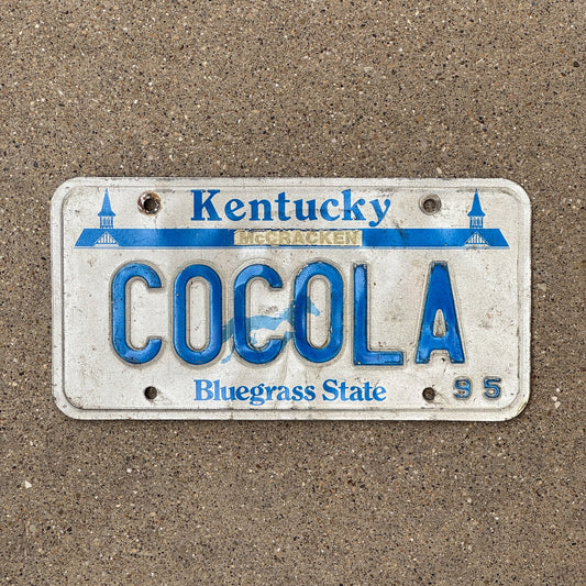 Photo of a 1995 Kentucky Vanity License Plate Auto Tag Garage Decor Vintage Coke Cola COCOLA