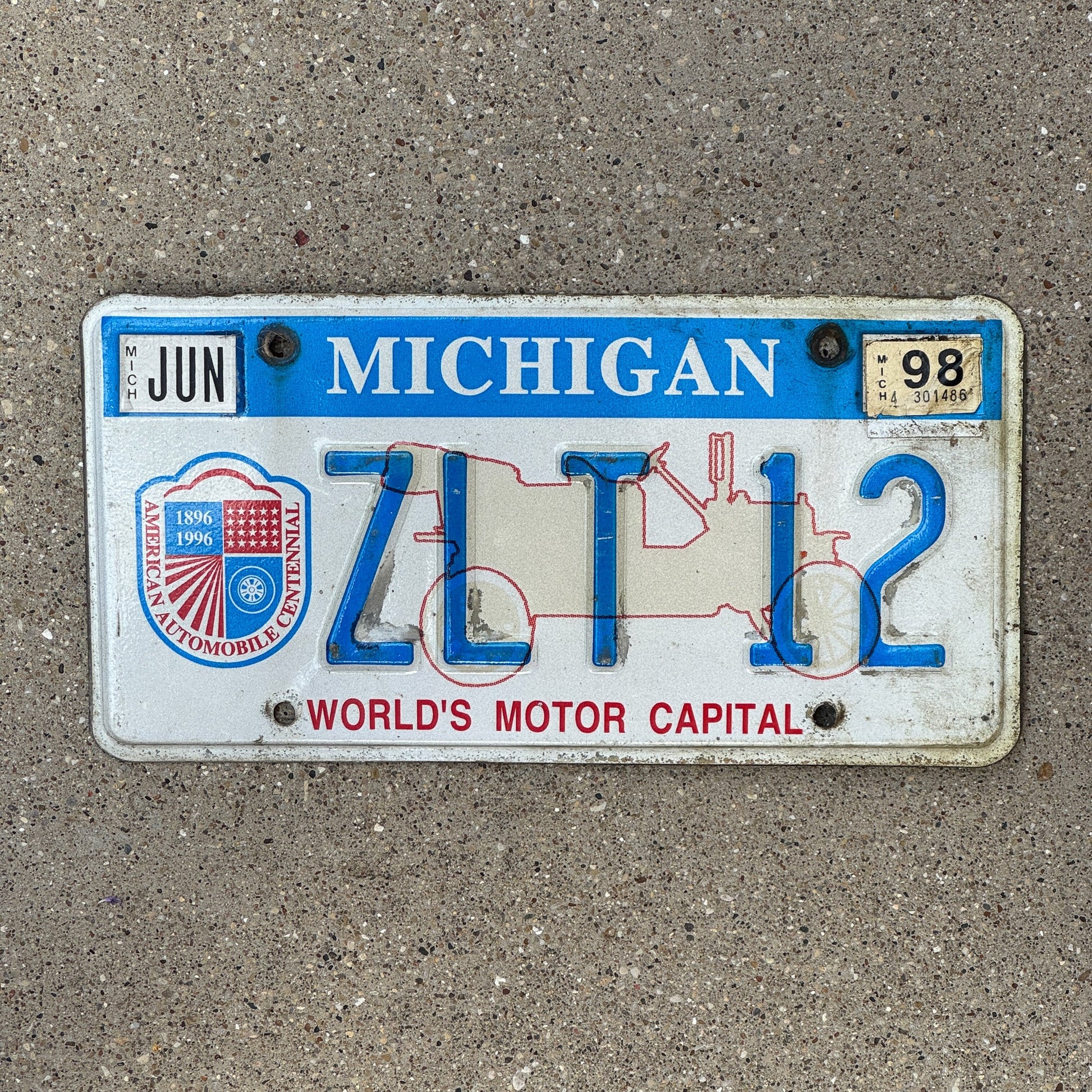 Photo of a 1996 1998 Michigan Graphic / Specialty License Plate Auto Tag Garage Decor Vintage World's Motor Capital ZLT 12