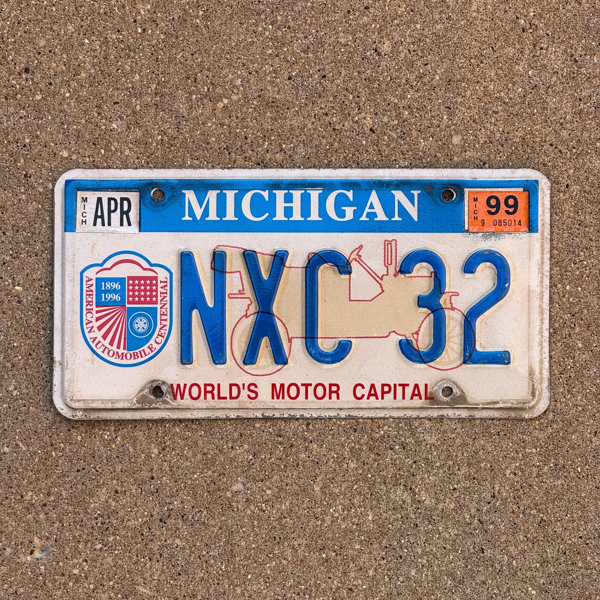 Photo of a 1996 1999 Michigan Graphic / Specialty License Plate Auto Tag Garage Decor Vintage World's Motor Capital NXC32