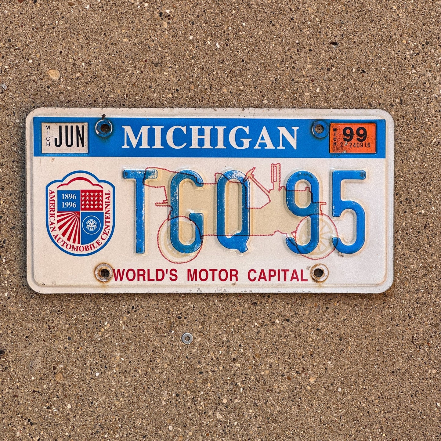 Photo of a 1996 1999 Michigan Graphic / Specialty License Plate Auto Tag Garage Decor Vintage World's Motor Capital TGQ 95
