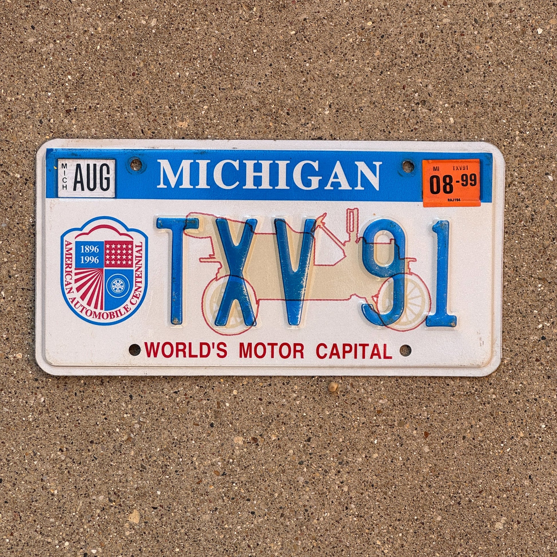 Photo of a 1996 1999 Michigan Graphic / Specialty License Plate Auto Tag Garage Decor Vintage World's Motor Capital TVX 91