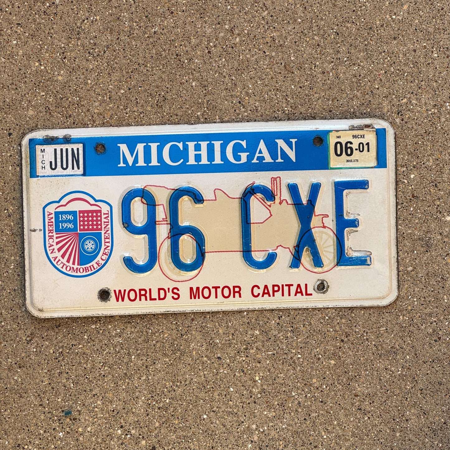 Photo of a 1996 2001 Michigan Graphic / Specialty License Plate Auto Tag Garage Decor Vintage World's Motor Capital 96 CXE