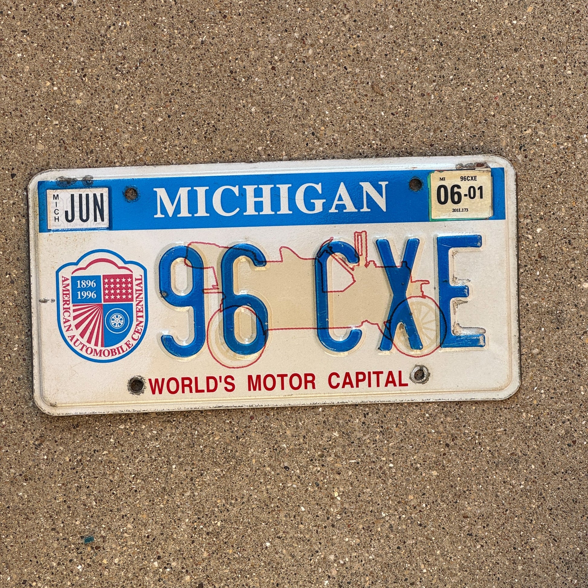 Photo of a 1996 2001 Michigan Graphic / Specialty License Plate Auto Tag Garage Decor Vintage World's Motor Capital 96 CXE